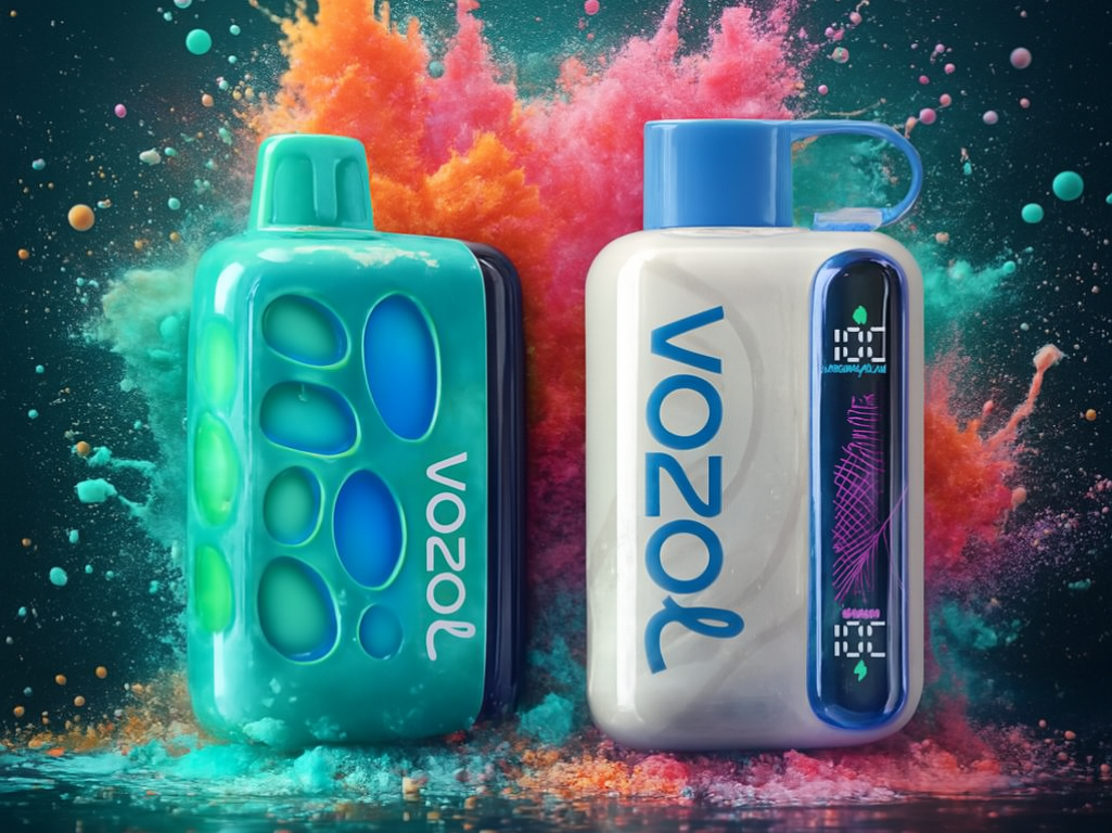 A dynamic product photograph showcases two disposable vape devices against a dark background with vibrant explosions of colored powder. The device on the left is a shiny teal-green with blue interior accents, and the one on the right is white with a blue mouthpiece and a luminous vertical screen. Both devices are set among splashes and reflections, centered in the frame with pink and orange powder clouds creating a striking contrast.